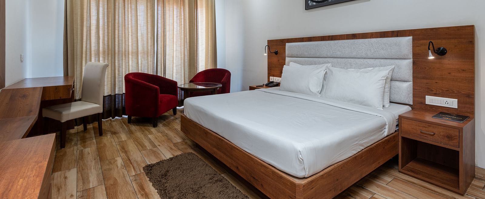 A Club Balcony Room featuring a bed, a teapoy and chairs at DLS The Classio